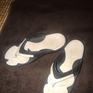 Crocs black and white flip flops